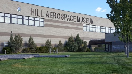 Exterior of Hill Aerospace Museum, featuring a modern building with large windows and landscaped green space.