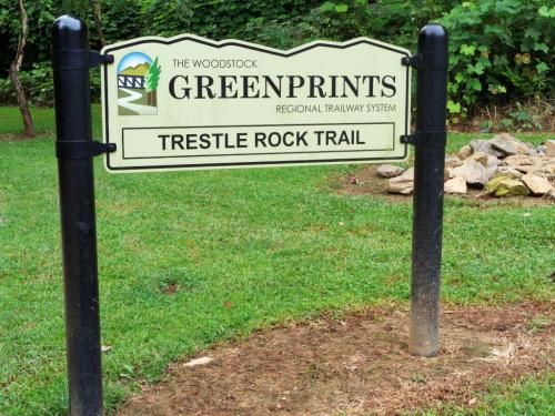 Sign for Trestle Rock Trail, part of the Woodstock Greenprints Regional Railway System, set in a grassy area.