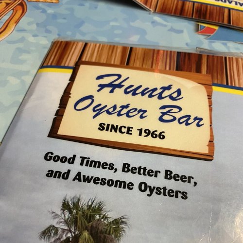 Sign for Hunt's Oyster Bar, established in 1966, promoting good times, better beer, and awesome oysters.