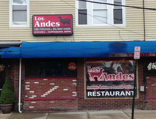 Signage for "Los Andes" restaurant featuring Bolivian and Peruvian cuisine, with a blue awning and decorative elements.