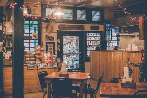 Cozy interior of a rustic café with wooden tables, vintage decor, and warm lighting.