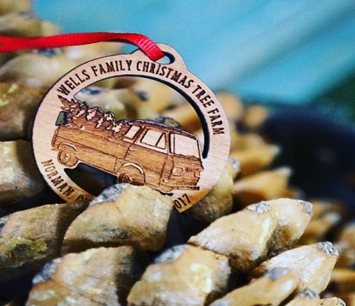 Wooden ornament featuring a truck with a Christmas tree, labeled "Wells Family Christmas Tree Farm 2017."