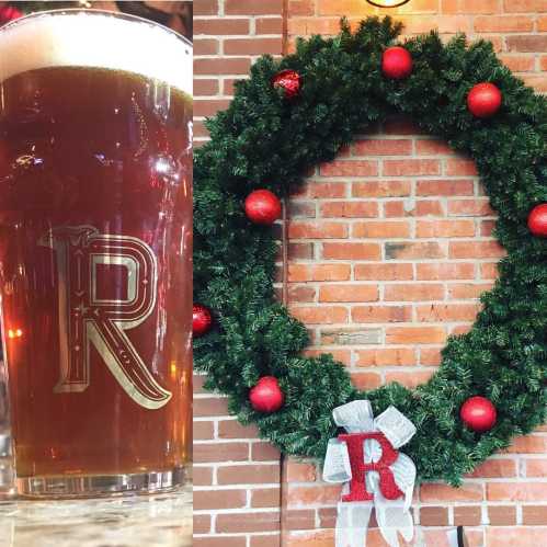 A festive wreath made of greenery and red ornaments, next to a glass of beer with an "R" logo.