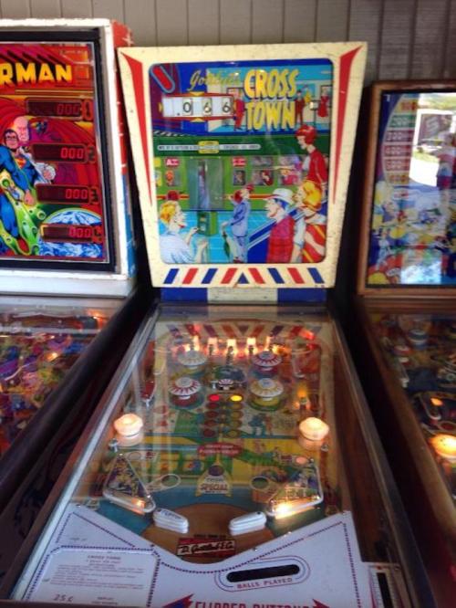 A vintage pinball machine titled "Crosstown" featuring colorful artwork and illuminated playfield elements.