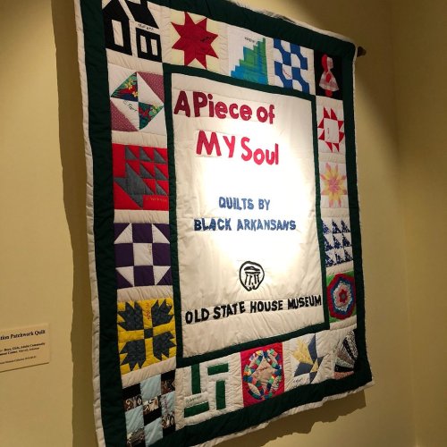 A colorful quilt titled "A Piece of My Soul" displayed at the Old State House Museum, showcasing designs by Black Arkansans.