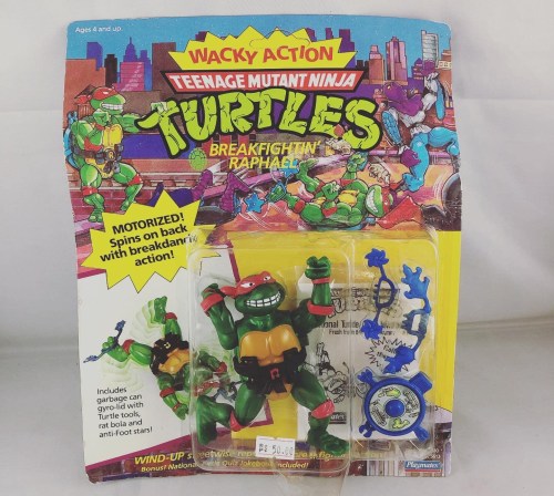A packaged action figure of Raphael from Teenage Mutant Ninja Turtles, featuring motorized spinning action.