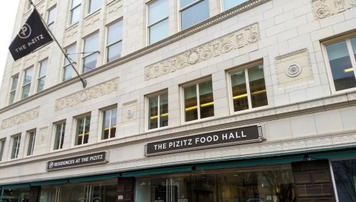 Exterior of The Pizitz building featuring the sign for The Pizitz Food Hall and decorative architectural details.