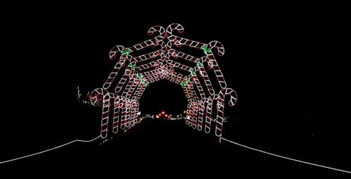 A festive archway made of candy cane lights against a dark background, creating a cheerful holiday atmosphere.