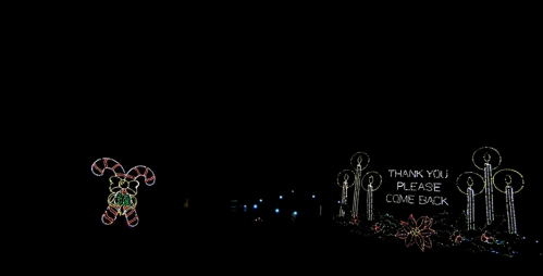 Colorful holiday lights featuring a candy cane character and a sign that says, "Thank you, please come back."
