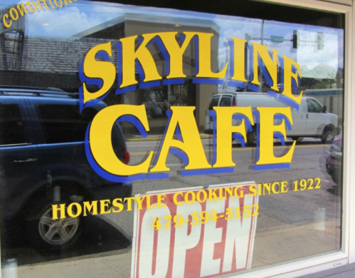 Sign for Skyline Cafe featuring "Homestyle Cooking Since 1922" and "Open" in bright yellow and red colors.