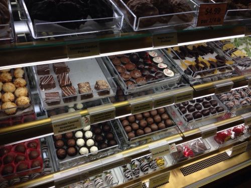 A display case filled with various chocolates and confections, including pralines, truffles, and chocolate-covered treats.