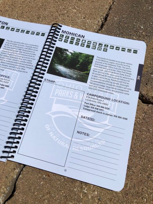 Open camping guide featuring information about Mohican campground, including location, office details, and a stamp area.