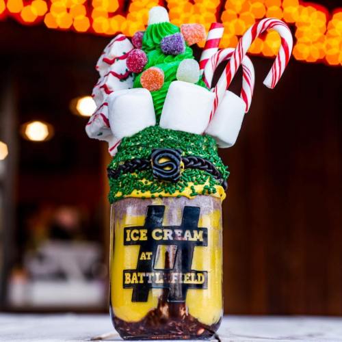 A colorful ice cream sundae topped with candy canes, marshmallows, and sprinkles in a jar labeled "Ice Cream at Battlefield."