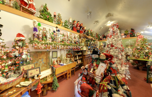 A festive room filled with Christmas decorations, including trees, nutcrackers, and various holiday ornaments.