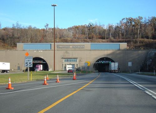 Entrance to the Allegheny Mountain Tunnel, with traffic cones and a speed limit sign visible.
