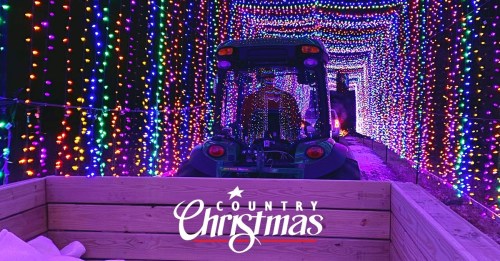 A tractor surrounded by colorful holiday lights in a festive tunnel, with "Country Christmas" text at the bottom.