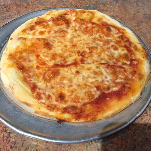 A freshly baked cheese pizza on a silver serving tray, with a golden crust and melted cheese.