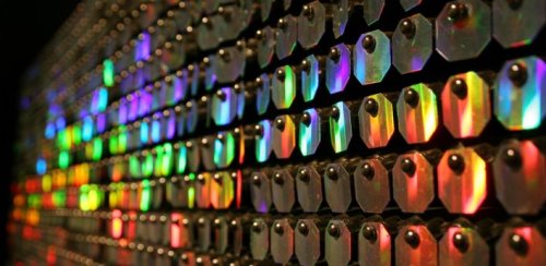 Close-up of a colorful, reflective surface with hexagonal shapes creating a vibrant, iridescent pattern.