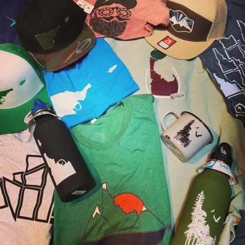 A collection of apparel and accessories featuring nature-themed designs, including hats, shirts, and water bottles.