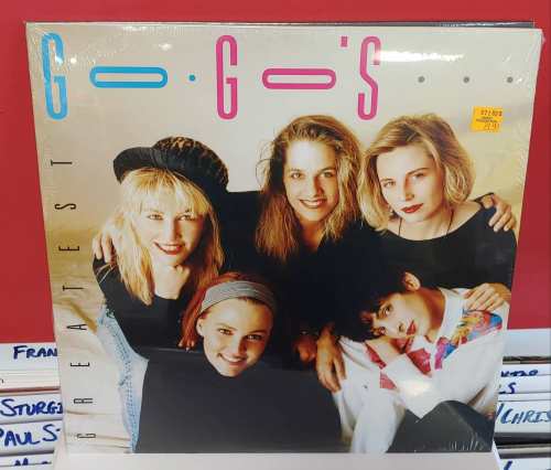 Album cover for "Greatest" by The Go-Go's featuring four women posing together, smiling, with colorful text.