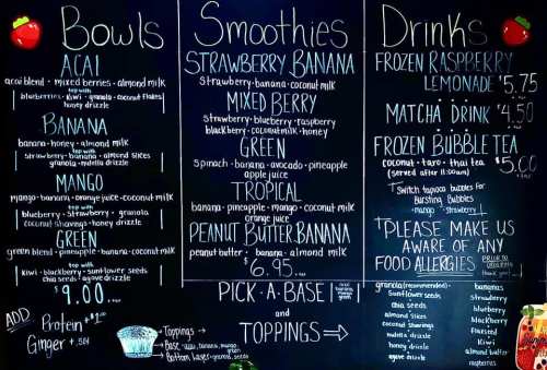 Menu board featuring bowls, smoothies, and drinks with various flavor options and prices.