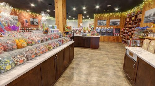 A colorful candy shop interior with jars of sweets, wooden shelves, and festive decorations.