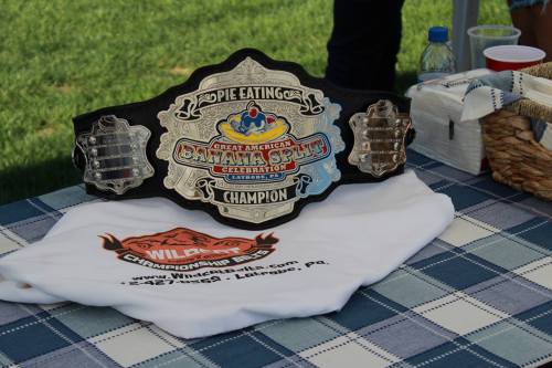 A championship belt for the Great American Banana Splits Pie Eating contest, displayed on a white shirt.