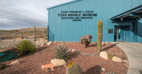 Exterior of the Titan Missile Museum with desert landscaping and a sign for the education and research center.