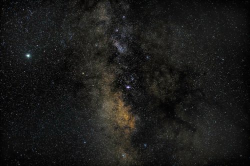 A stunning view of a starry night sky, featuring countless stars and a glimpse of the Milky Way galaxy.