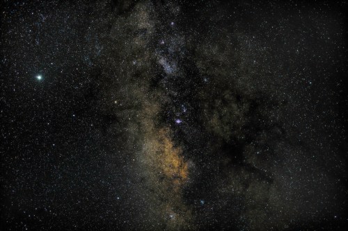 A stunning view of the night sky filled with countless stars and a faint band of the Milky Way galaxy.