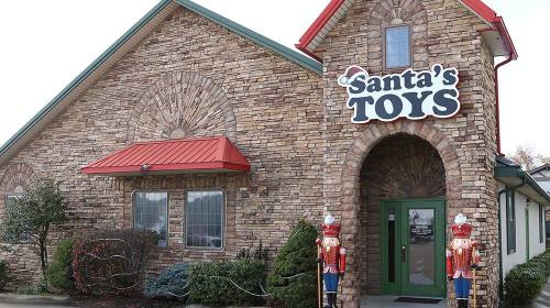 Exterior of Santa's Toys store featuring a stone facade and festive decorations, including nutcracker figures.