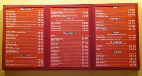 Menu board featuring burgers, baked potatoes, dinners, sandwiches, side orders, salads, and dogs with prices listed.