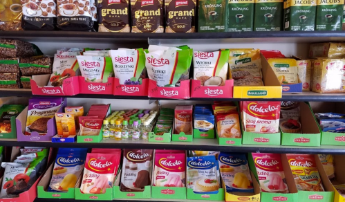 Shelves filled with various brands of snacks, desserts, and instant food products in colorful packaging.