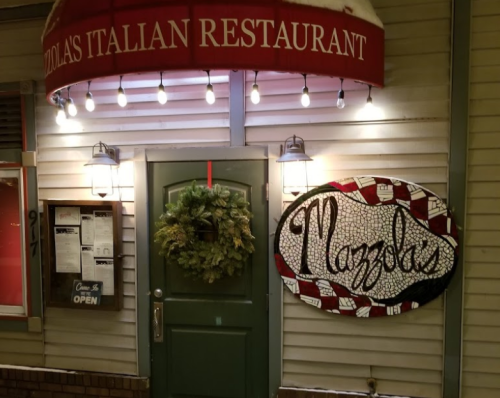 Exterior of Mazzola's Italian Restaurant, featuring a festive wreath and a sign with the restaurant's name.