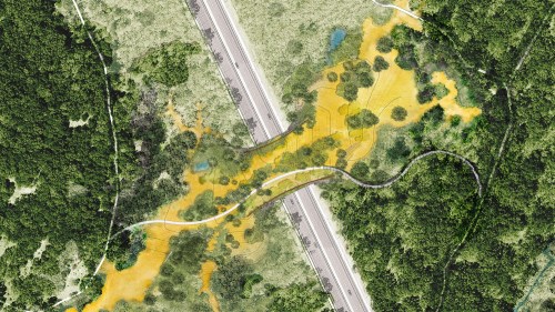 Aerial view of a landscape featuring a winding path, trees, and a highway, with yellow and green areas indicating vegetation.