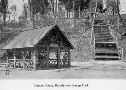 Historic image of a gazebo at Brandywine Springs Park, with stairs leading up a wooded hillside in the background.