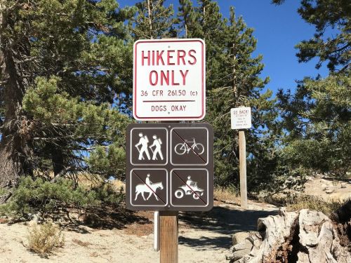 Sign indicating "Hikers Only" with symbols for hiking, biking, horseback riding, and strollers. Dogs allowed.