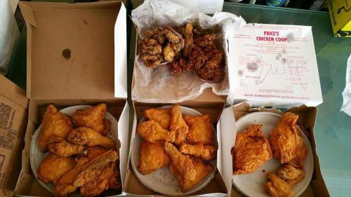 Three boxes of fried chicken, with crispy wings and drumsticks, arranged on plates, alongside a takeout receipt.