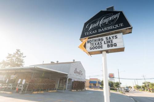 Sign for a BBQ restaurant reads "Nothing says Texas like Goode BBQ," with a sunny exterior view of the building.