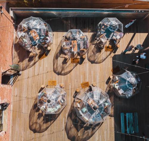 Aerial view of outdoor dining area with several covered tables on a wooden deck.