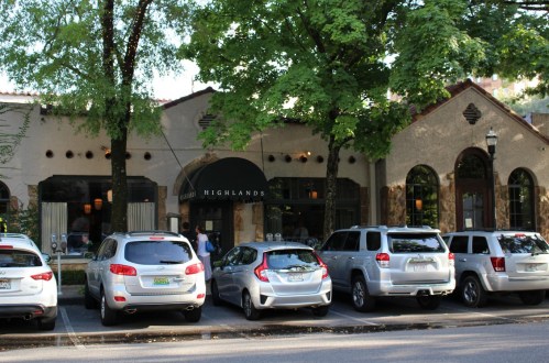 Exterior of a restaurant named "Highlands," with several parked cars and trees in front.