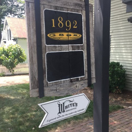Sign for White's Mercantile, established in 1892, with an arrow pointing towards the store.