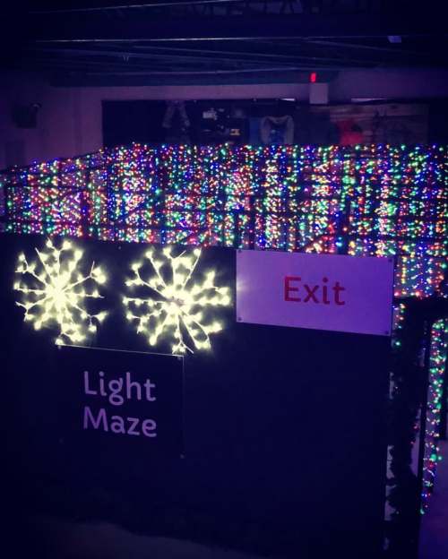 A colorful light maze with twinkling lights and an "Exit" sign visible.