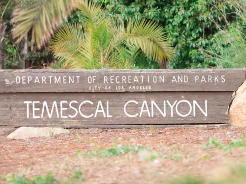 Sign for Temescal Canyon, Department of Recreation and Parks, City of Los Angeles, surrounded by greenery.