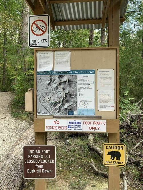 Trailhead sign with map and rules: no bikes, no climbing, foot traffic only, and caution for bears in the area.