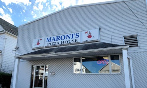 Exterior of Maroni's Pizza House with a sign and an "Open" neon light in the window.