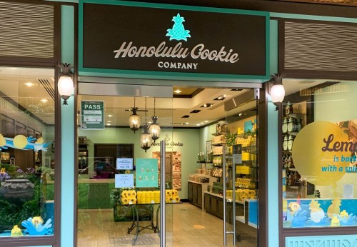Storefront of Honolulu Cookie Company featuring a bright, inviting design with tropical decor and cookie displays.