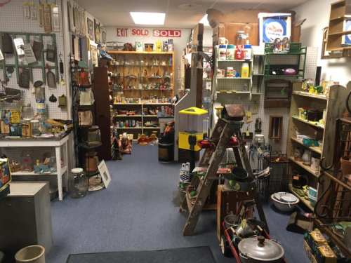 A vintage shop filled with various antiques, collectibles, and nostalgic items on display along the walls and shelves.