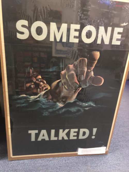 A vintage poster featuring a hand reaching out of water with the text "SOMEONE TALKED!" in bold letters.