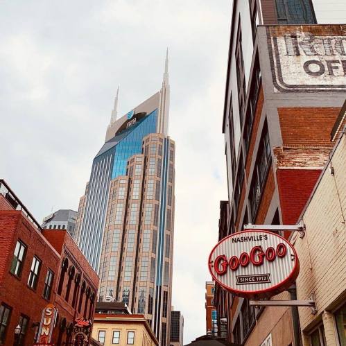 View of Nashville's skyline featuring the tall AT&T Building and a vintage Goo Goo candy sign.